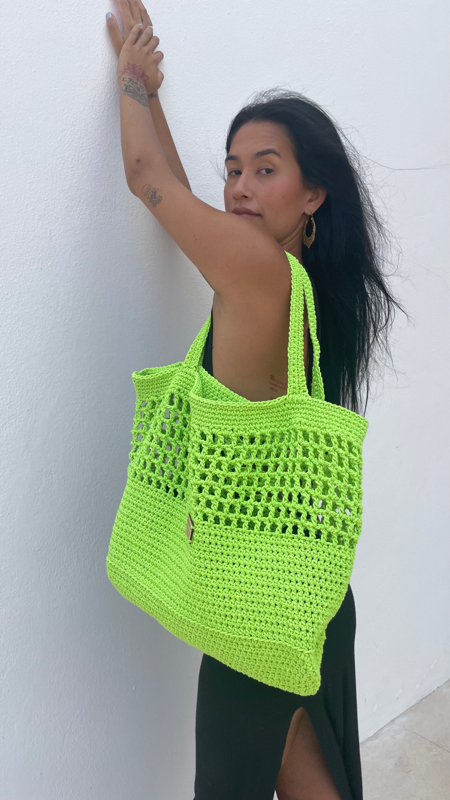 We are crazy about this lime neon vibrant color. This bag has been hand crocheted from 100% cotton .