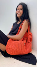 Load image into Gallery viewer, Vibrant orange thread was crochet to make this lovely tote.
