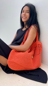 Vibrant orange thread was crochet to make this lovely tote.